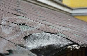 Asphalt shingles damage. Roofing shingles asphalt. Fixing damaged roof shingles.