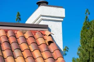 Roof tiles shifted by strong winds during storm require repair to prevent water leak and interior damage.